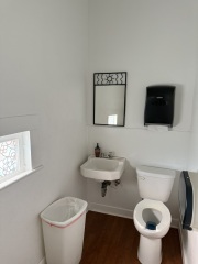 Women's restroom upstairs, behind stage.